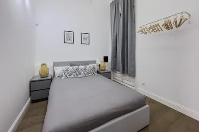 a bedroom with a large bed and a window at Apartamento Rambla Cataluña 35 in Barcelona