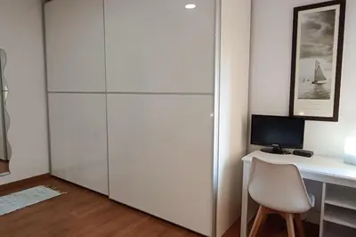 a white desk with a computer and a chair at Apartamento Gran Via para 6 en el centro de Premià in Premiá de Mar