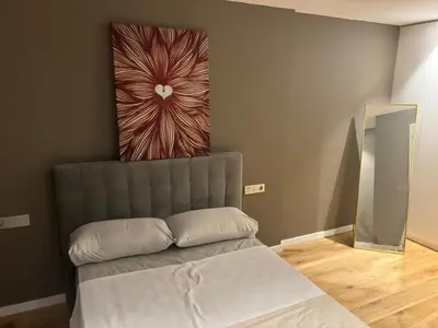 a couch in a room with a painting on the wall at chalet barcelona in Barcelona