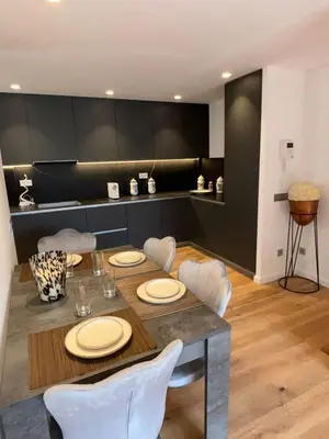 a dining room with a table and white chairs at chalet barcelona in Barcelona