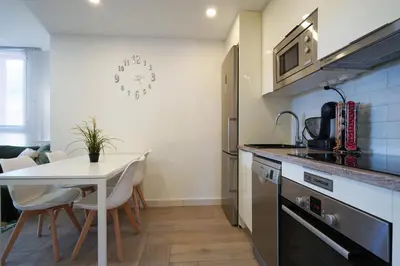 a kitchen with a table and a white table and chairs at Apartment-4people-Parking-Castelledefels-Bikes-Bbq in Castelldefels