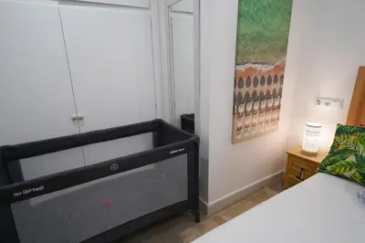 a bedroom with a black dresser next to a bed at Apartment-4people-Parking-Castelledefels-Bikes-Bbq in Castelldefels