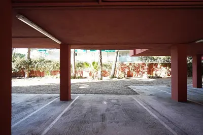 an empty room with red columns in a building at Apartment-4people-Parking-Castelledefels-Bikes-Bbq in Castelldefels