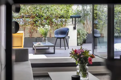 a patio with a blue chair and a table at The Passage Homes - Simaba Group in Barcelona