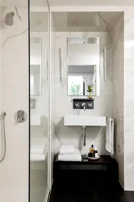 a white bathroom with a sink and a mirror at The Passage Homes - Simaba Group in Barcelona