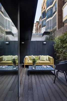 a patio with two couches on a wooden deck at The Passage Homes - Simaba Group in Barcelona