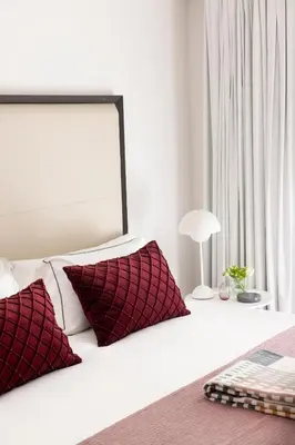 a bedroom with a bed with red and white pillows at The Passage Homes - Simaba Group in Barcelona