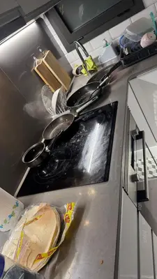 a kitchen counter with many pots and pans on it at just a dirty sofa in Barcelona