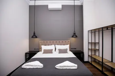 a bedroom with a bed with two towels on it at beautiful cosy modern apartment ,19th century building in Barcelona