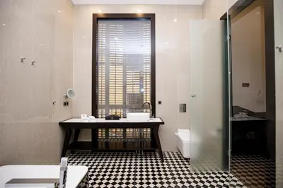 a bathroom with a sink and a toilet and a window at beautiful cosy modern apartment ,19th century building in Barcelona