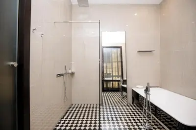 a bathroom with a shower and a tub and a sink at beautiful cosy modern apartment ,19th century building in Barcelona