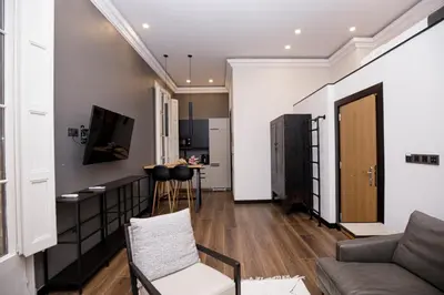 a living room with a couch and a table at beautiful cosy modern apartment ,19th century building in Barcelona