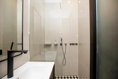 a bathroom with a shower with a glass door at beautiful cosy modern apartment ,19th century building in Barcelona