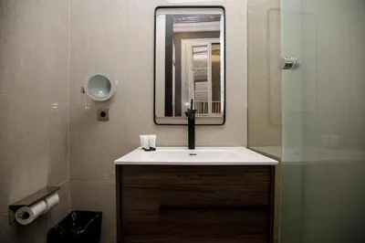 a bathroom with a sink and a mirror at beautiful cosy modern apartment ,19th century building in Barcelona