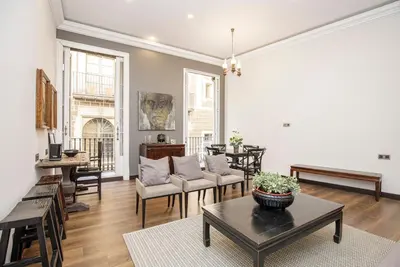 a living room with a couch and a table at beautiful trendy spacious apartment very central location in Barcelona