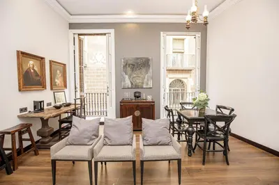 a living room with a table and chairs at beautiful trendy spacious apartment very central location in Barcelona