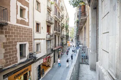 a street in a city with people walking down it at beautiful trendy spacious apartment very central location in Barcelona