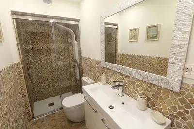 a bathroom with a toilet and a sink and a shower at Sitges Centre Mediterranean House- 5 Bedroom, 4 Bathroom, Terrace Courtyard, Private Rooptop Pool in Sitges