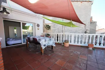 a patio with a table and chairs on a balcony at Masnou Chill in Masnou