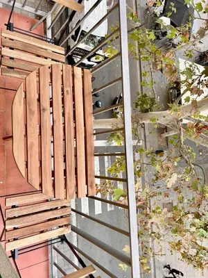a wooden bench sitting on top of a stairs at Barcelona Raval in Barcelona
