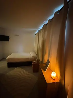 a room with two beds and a table with a lamp at Tranquilo y céntrico in Barcelona