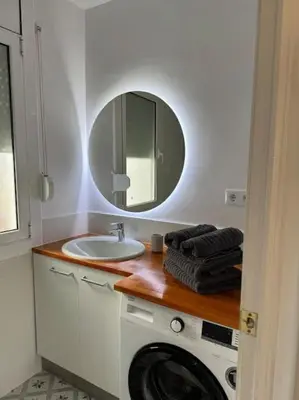 a bathroom with a sink and a washing machine at Ático gran terraza cerca BCN in Castelldefels