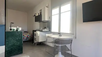 a small kitchen with a sink and a window at Top Studio with Terrace in Barcelona