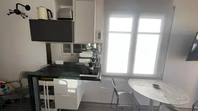 a kitchen with a black counter and a window at Top Studio with Terrace in Barcelona