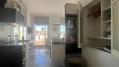 a kitchen with white cabinets and a counter top at Top Studio with Terrace in Barcelona
