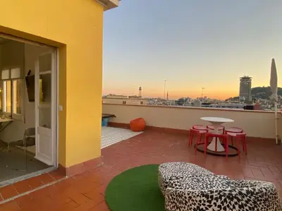 a balcony with a table and chairs and a view of a city at Top Studio with Terrace in Barcelona