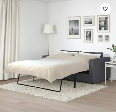 a bed in a bedroom with a white wall at Winahost Barcelona Provenza in Barcelona