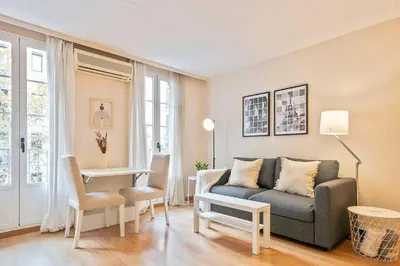 a living room with a couch and a table at Winahost Barcelona Provenza in Barcelona