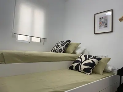 a bedroom with two beds with pillows on it at Jordi home 15 minutes to center by train in Sant Adria de Besos