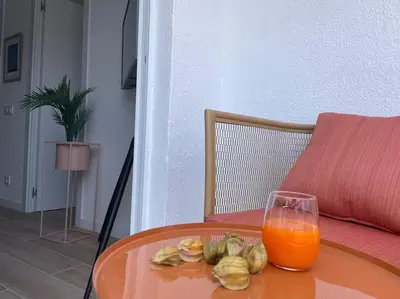 a glass of orange juice sitting on top of a table at Jordi home 15 minutes to center by train in Sant Adria de Besos