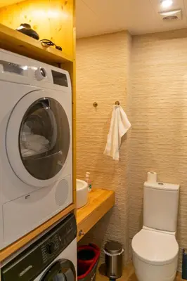 a bathroom with a toilet and a microwave at 
