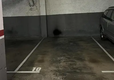 a parking garage with a car parked in it at Espacioso con patio interior in Sabadell