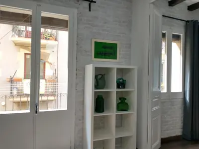 a room with a book shelf with green vases on it at Barceloneta Beach Apartments in Barcelona
