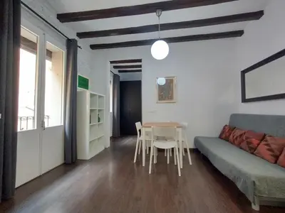 a living room with a couch and a table at Barceloneta Beach Apartments in Barcelona