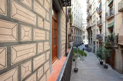 an alley in a city with buildings and plants at El Born - Barcelona Center Apartment in Barcelona