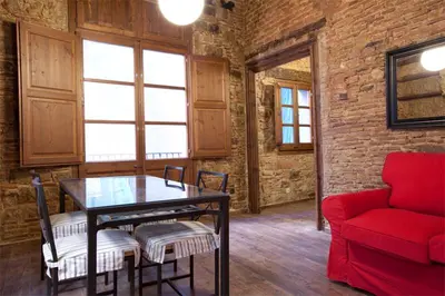 a living room with a table and a red couch at El Born - Barcelona Center Apartment in Barcelona