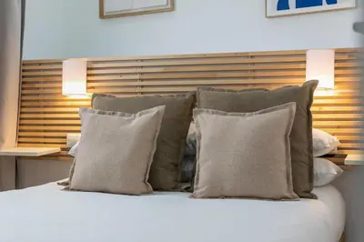 a bedroom with a large white bed with white pillows at Livinn House - Self Check in in Hospitalet de Llobregat