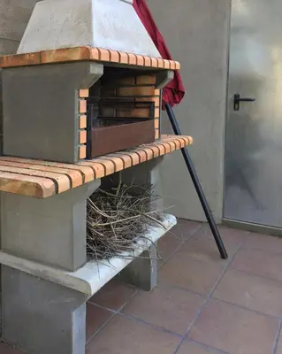 a bird house with a bird nest on a bench at Eco house of oak, 15 min to BCN Max Pax 8 in Sant Cugat del Vallès