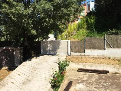 a garden with a plant in the middle of a sidewalk at Eco house of oak, 15 min to BCN Max Pax 8 in Sant Cugat del Vallès