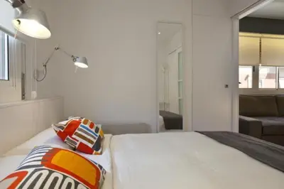 a bedroom with a bed with two pillows on it at Barceloneta near Beach Apartments in Barcelona