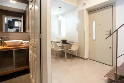a kitchen and a dining room with a table at Barceloneta Apartment in Barcelona