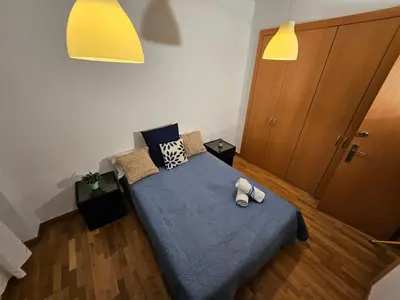 a bedroom with a bed with a blue comforter at Near Ramblas apartment 3 room flat Min 32 days in Barcelona