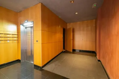 an empty locker room with wooden walls and a elevator at Near Ramblas apartment 3 room flat Min 32 days in Barcelona