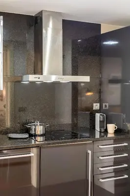 a kitchen with a stove and a counter top at Canela Homes BARCELONA FÒRUM in Sant Adria de Besos