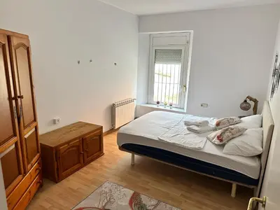 a small bedroom with a bed and a window at Relax Holiday Home in Vallromanas