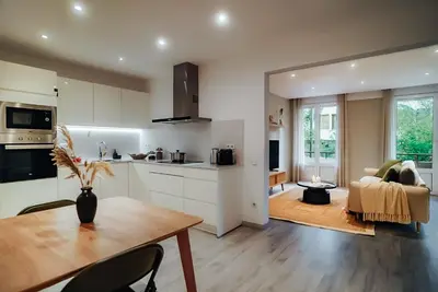 a kitchen and living room with a table and chairs at Casa Central in Barcelona